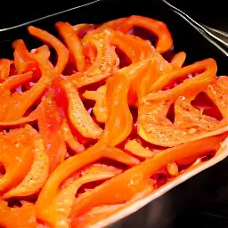 the roasted red bell peppers are done cooking and can be removed from the oven.