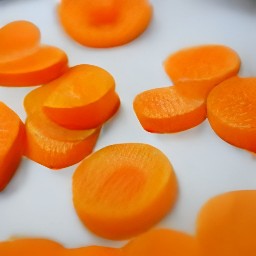 carrot peels, carrot slices, red bell pepper peelings, red bell pepper slices, cucumber halves, onion peelings, onion slices