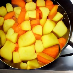 a pan of boiled potatoes, rutabagas, and carrots.